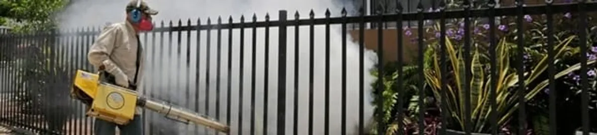 Mosquito control technician fogging a yard perimeter for mosquito reduction in Columbia, SC